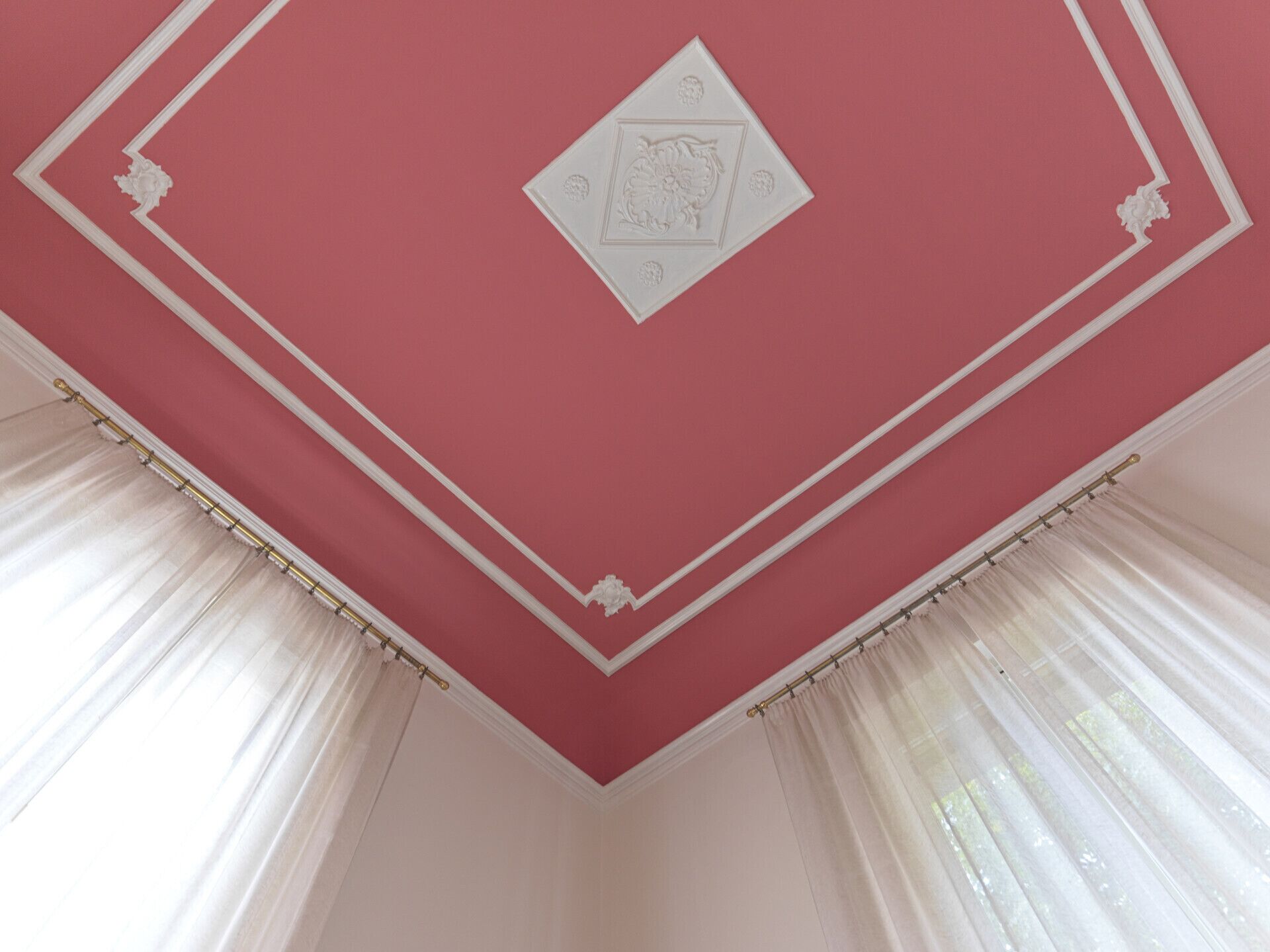 Une pièce avec un plafond rouge, des moulures blanches et un panneau décoratif en forme de losange.