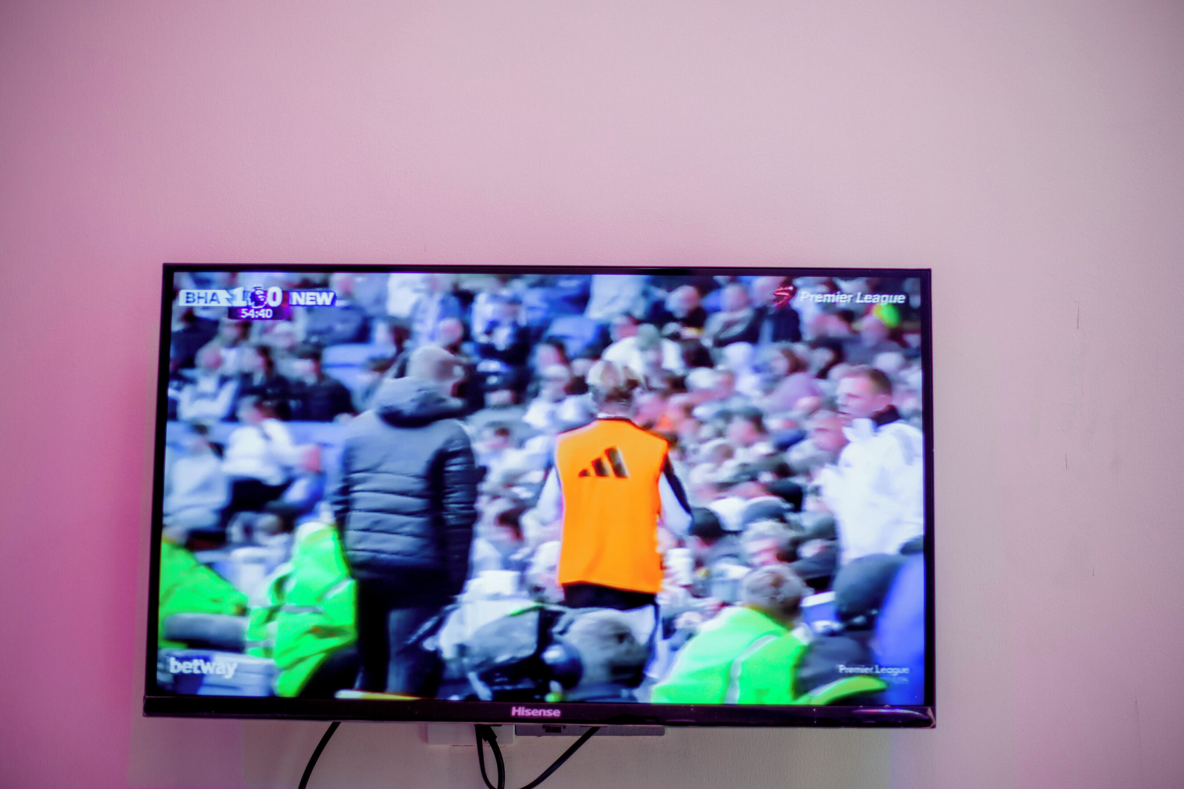 A television displaying a sports event with a crowd in the background.
