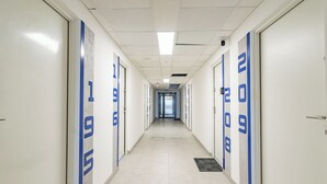 A long, narrow hallway with doors numbered 1 to 9.
