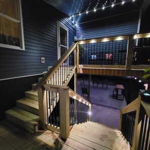 Step out to an outdoor space with a deck featuring comfortable seating and dining areas.