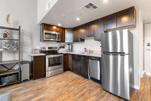 Fridge, dishwasher, coffee/tea maker, cookware/dishes/utensils