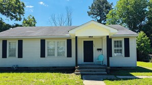 A single-story house with a front porch, a mailbox, and a number '306' on the door.