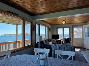 Enjoy a peaceful retreat with a water view, comfortable seating, and a round table for dining or relaxation.