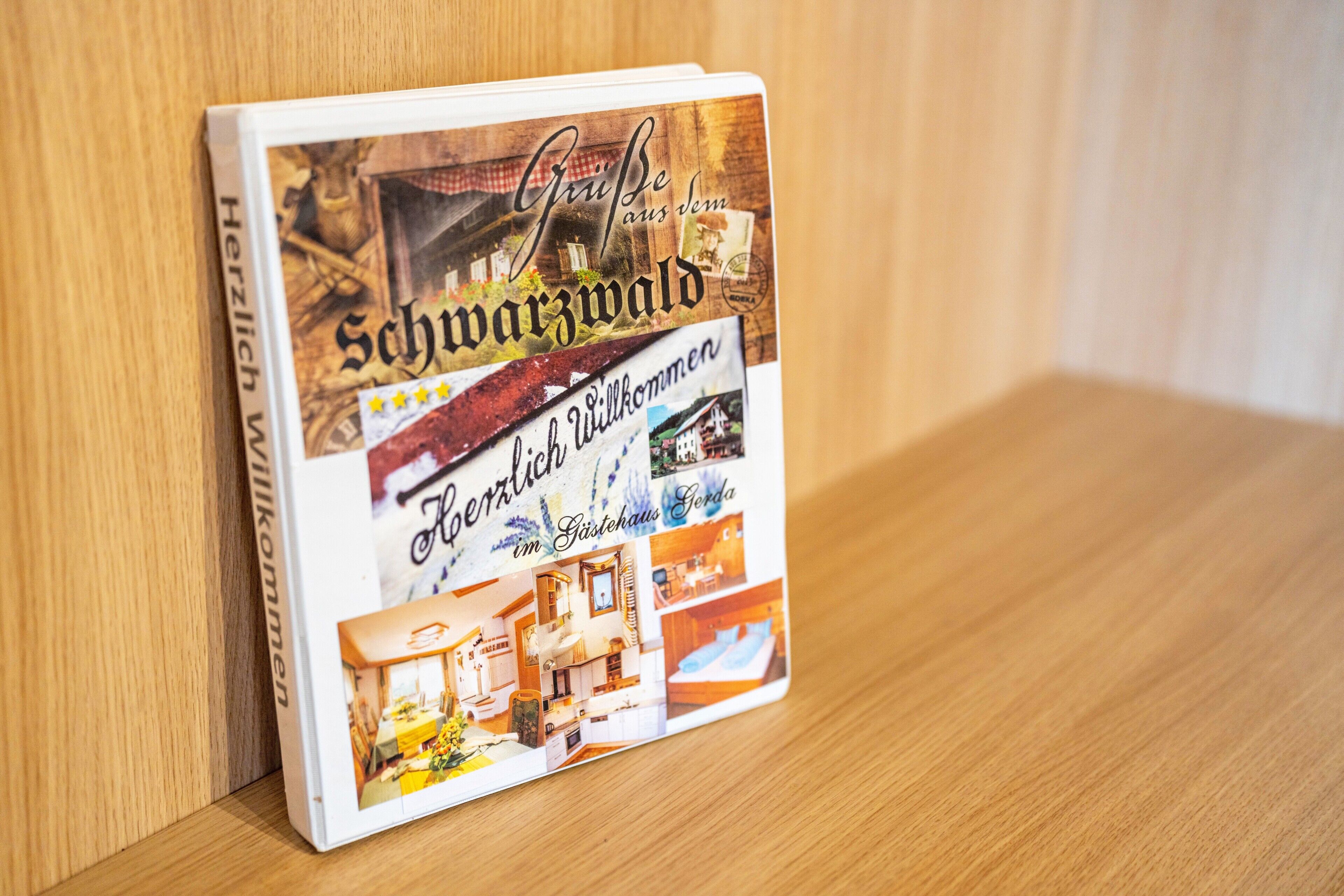 A book with a cover featuring a traditional building and interior images of a hotel room.