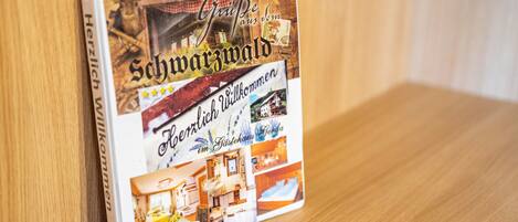 A book with a cover featuring a traditional building and interior images of a hotel room.