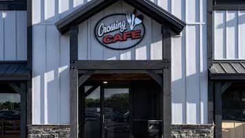 Un edificio con un cartel que dice 'Crossing Cafe' sobre la entrada.