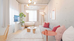Un salon moderne avec un canapé, une table basse, un téléviseur et une plante.