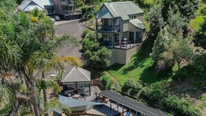 A resort with a large swimming pool, covered seating areas, and a view of surrounding buildings. - Blackwood at Boardwalk Villas Metung (Metung)