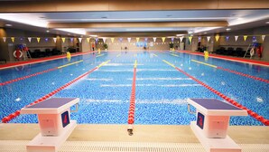 A large indoor swimming pool with lane dividers, lifeguard chairs, and a lifebuoy. - Beijing CSN Pearl Hotel (Langfang)