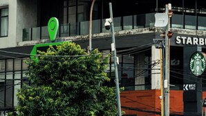 A modern building with a sign for 'Primahotel' and a Starbucks drive-thru. - d'primahotel Harmoni Jakarta-Hayam Wuruk (Jakarta)