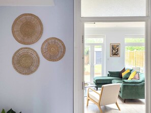 A room with a green sofa, a chair, and three woven wall hangings. - 5 BR 3Bathroom Modern House with Garden near Hampstead Heath Sleeps 10 (Greater London)