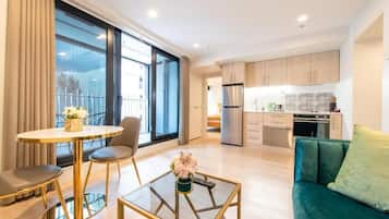 Deluxe Apartment, Balcony | Living area | Flat-screen TV