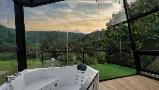 A modern spa area with a large hot tub, wooden deck, and a scenic view of a lush valley. - The Blackberry Retreat Kandy (Kandy)