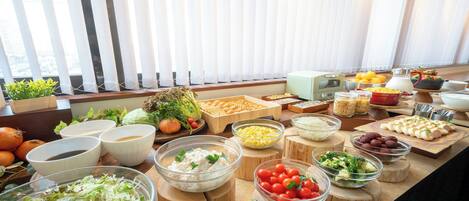 A buffet table with various food items and condiments.