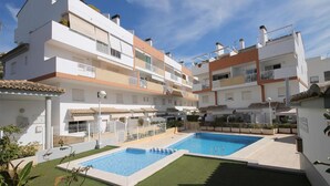 A multi-story residential building with a swimming pool and a small garden area. - Apartment- Charly in Javea (Javea)