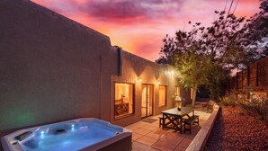 A hot tub and patio area with a sunset view.