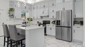 A modern kitchen with white cabinets, a stainless steel refrigerator, and a marble floor. - Charming Family Getaway Near Medina River! (Bandera)