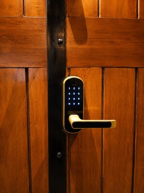 A door with a numeric keypad lock and a keyhole.