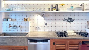 Una cocina moderna con lavavajillas, estufa a gas y fregadero.