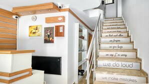 A staircase with motivational phrases on the steps and a modern interior with wooden accents and artwork. - Viva Sirkeci Butik Otel (Istanbul)
