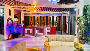 Enjoy live performances and events in this stylish space with a central bar, comfortable seating, and unique ceiling design.