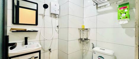 A bathroom with a toilet, sink, and shower.