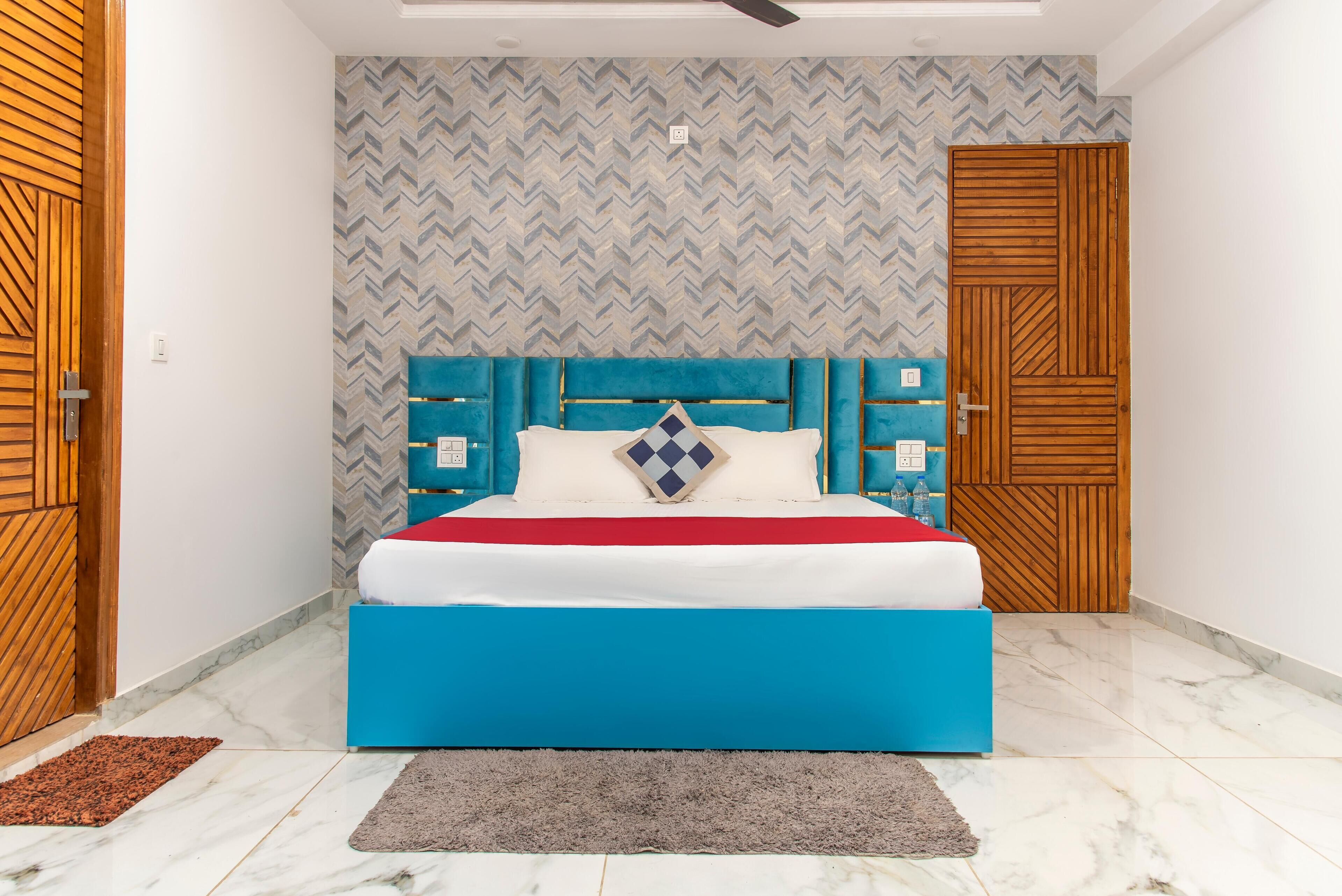 Ein Schlafzimmer mit einem Bett, einer Wand mit Muster und Holztüren.
