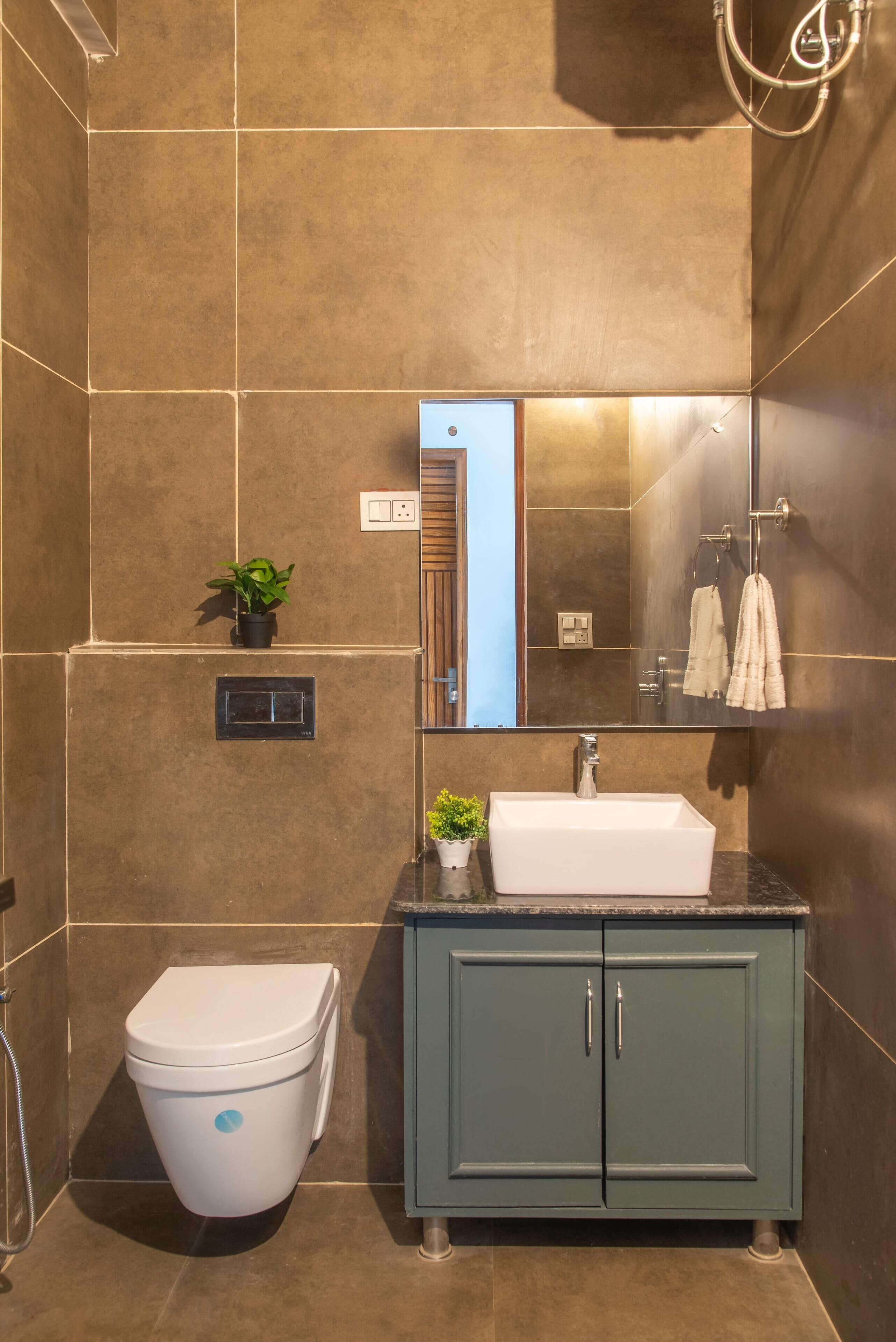 A modern bathroom with a white toilet, a sink, and a cabinet.