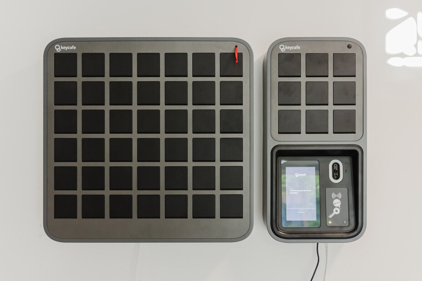 Two keypads with the 'keycafe' logo, one larger and one smaller, and a smaller device with a screen and buttons.