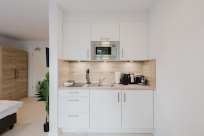 Fridge, microwave, stovetop, coffee/tea maker