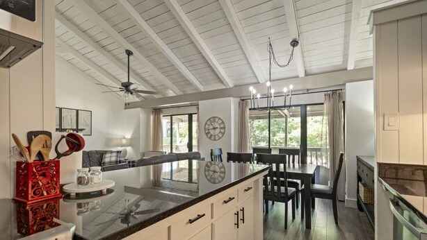 A modern kitchen with a central island, a dining area with a table and chairs, and a ceiling fan. - Lake Escape w/ Deck & Patio (Horseshoe Bay)