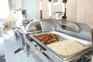 A buffet with a variety of dishes including rice and stir-fried vegetables. - Ajwa Plaza Premium Hotel (Bukhara)