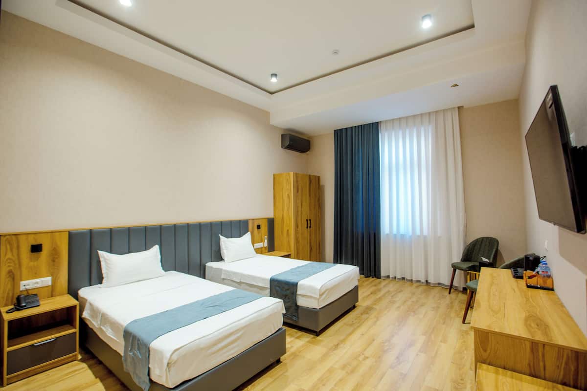 Standard Double or Twin Room | In-room safe, desk, laptop workspace, blackout drapes