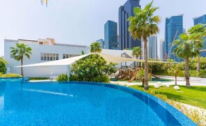 A swimming pool with a cityscape in the background.