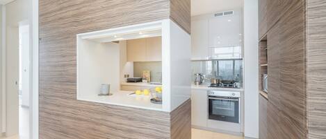 A modern kitchen with a built-in oven and a microwave.