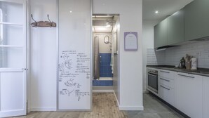 A modern kitchen with white cabinets, a stainless steel range hood, and a wooden floor. - Central Cozy Nest With Parking, Bogliasco (Bogliasco)
