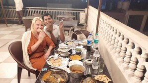 A dining table with various dishes and a water bottle. - Hotel Taj Royal (Agra)