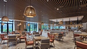 A spacious indoor area with multiple seating arrangements, large windows, and a modern ceiling design. - Q-Box Hotel Hangzhou Bay Ningbo (Ningbo)