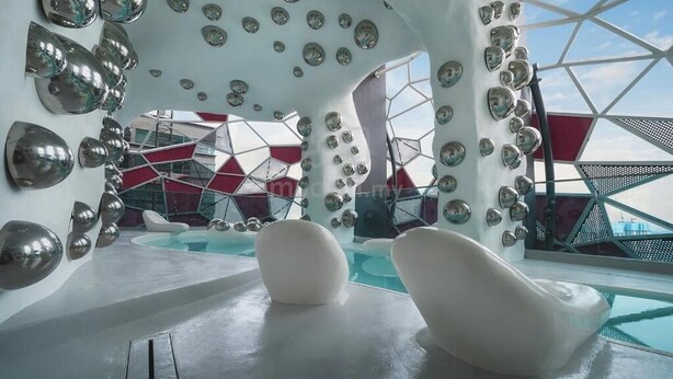 A modern interior with a unique geometric design, featuring a pool area and reflective surfaces. - Comfy Arte Plus Ampang City 7PAX-3BR-2CP (Kuala Lumpur)
