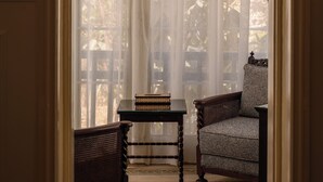 A room with a large window, a chandelier, a patterned floor, and two armchairs. - Private fully serviced villa in Maadi, with a private pool, kitchen and garden. (Cairo Governorate)