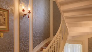 A grand staircase with white railings and a patterned carpet. - Private fully serviced villa in Maadi, with a private pool, kitchen and garden. (Cairo Governorate)