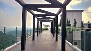 A covered outdoor terrace with a clear view of the cityscape and greenery. - Damansara Seresta (Batu Caves)
