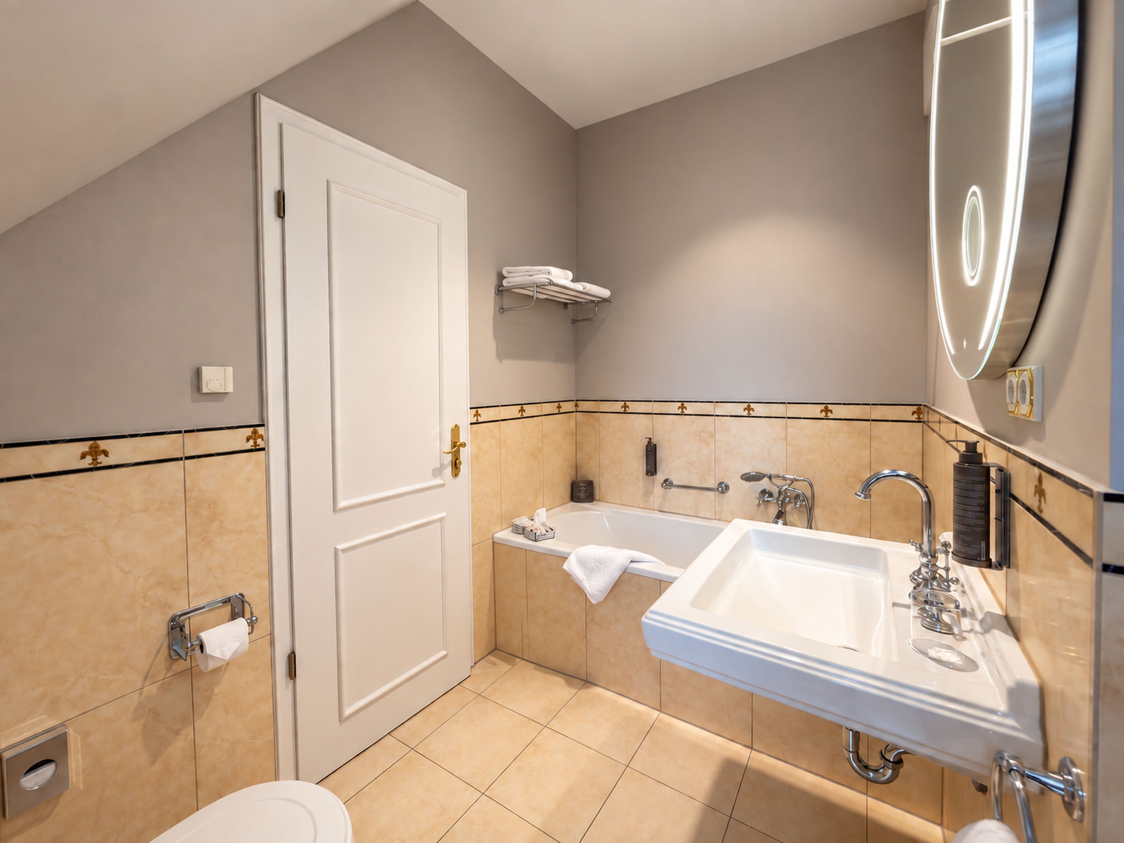 A modern bathroom with a bathtub, a sink, and a toilet.
