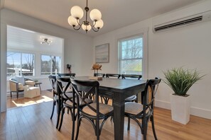A dining area with a large table, chairs, and a chandelier. - Pet-Friendly York Beach Vacation Rental | Walk to Cape Neddick Beach (York)
