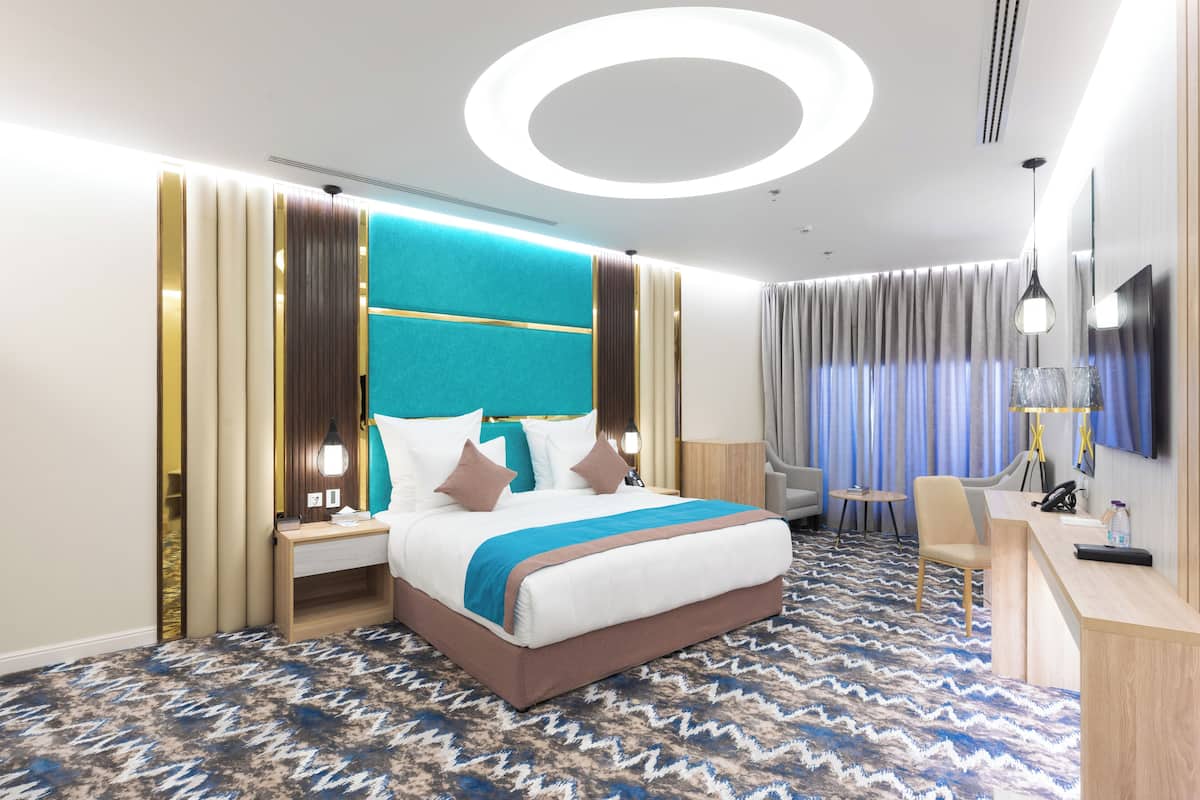 Junior Suite | 1 bedroom, in-room safe, blackout drapes, iron/ironing board
