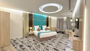 Junior Suite | 1 bedroom, in-room safe, blackout drapes, iron/ironing board