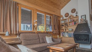 En hyggelig stue med en sofa, et træbord og en bogreol.