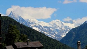 A mountain landscape with snow-capped peaks and a forested valley. - Très agréable 2 pièces contemporain, idéal pour 2 à 4 personnes, situé dans une petite résidence de (St-Luc)