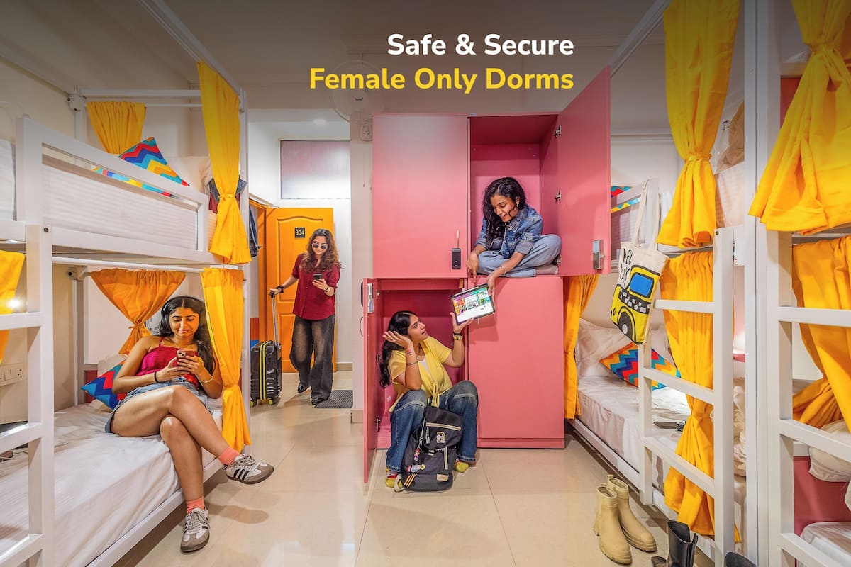 A dormitory with bunk beds, yellow curtains, and a sign indicating it's a female-only dorm.
