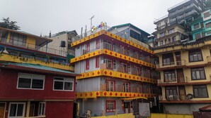 A multi-story building with balconies and a sign that reads "Vogt". - goSTOPS Mcleodganj, Mall Road (McLeod Ganj)